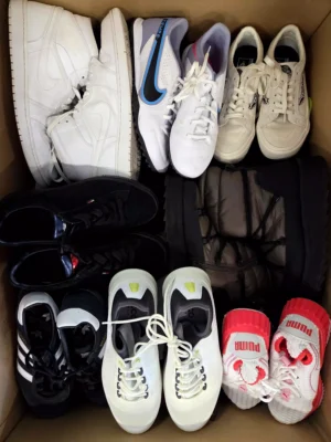 The photo shows a package with footwear in the category SH.