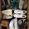 The photo shows a package with footwear in the category SH.