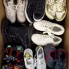 The photo shows a package with footwear in the category SH.