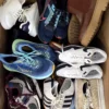 The photo shows a package with footwear in the category SH.