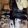 The photo shows a package with footwear in the category SH.