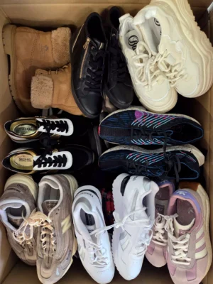The photo shows a package with footwear in the category SH.