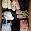 The photo shows a package with footwear in the category SH.