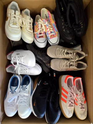 The photo shows a package with footwear in the category SH.