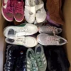 The photo shows a package with footwear in the category SH.
