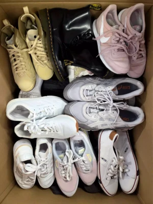 The photo shows a package with footwear in the category SH.