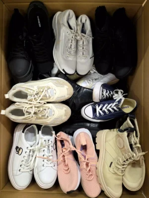 The photo shows a package with footwear in the category SH.