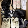 The photo shows a package with footwear in the category SH.