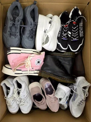 The photo shows a package with footwear in the category SH.