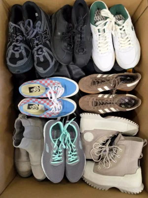 The photo shows a package with footwear in the category SH.