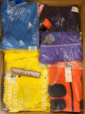 The photo shows a package with clothing in the category AJS.