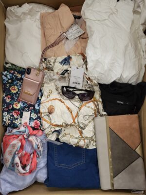 The photo shows a package with clothing in the category TSC.