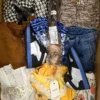 The photo shows a package with clothing in the category SN.