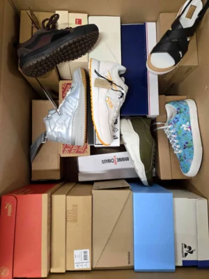 The photo shows a package with footwear in the category AS.