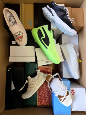The photo shows a package with footwear in the category AS.
