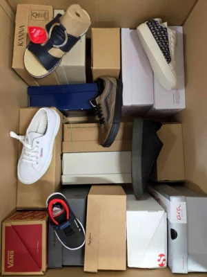 The photo shows a package with footwear in the category AS.