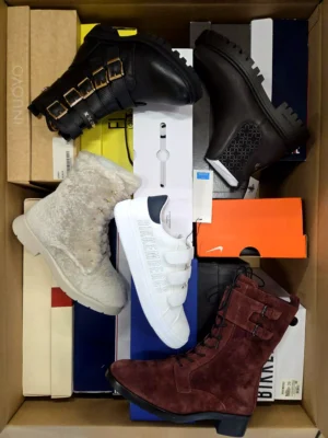 The photo shows a package with footwear in the category AS.