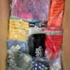 The photo shows a package with clothing in the category ABW.