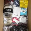 The photo shows a package with clothing in the category ABW.
