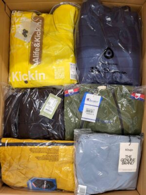 The photo shows a package with clothing in the category AJS.