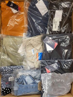 The photo shows a package with clothing in the category AW.