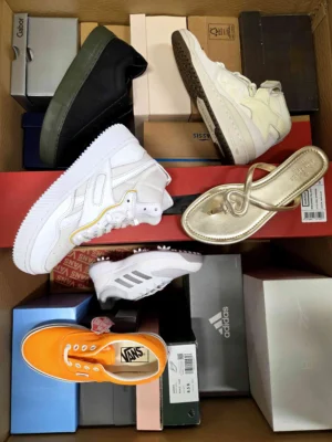 The photo shows a package with footwear in the category AS.