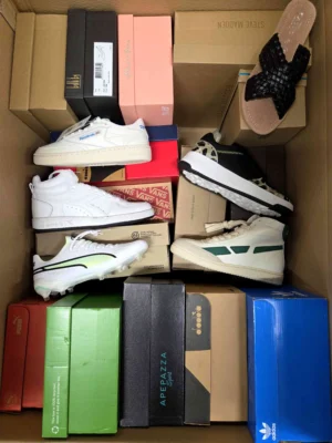 The photo shows a package with footwear in the category AS.