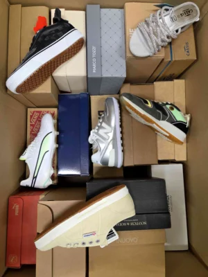 The photo shows a package with footwear in the category AS.