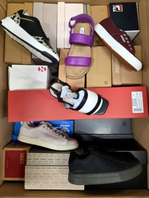 The photo shows a package with footwear in the category AS.