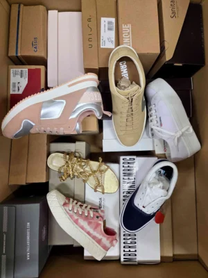 The photo shows a package with footwear in the category AS.