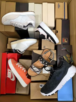 The photo shows a package with footwear in the category AS.