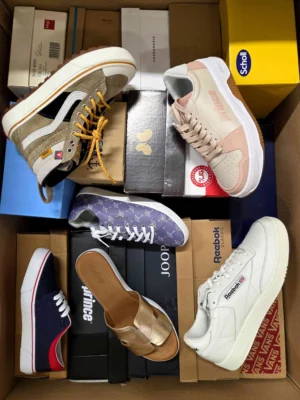 The photo shows a package with footwear in the category AS.