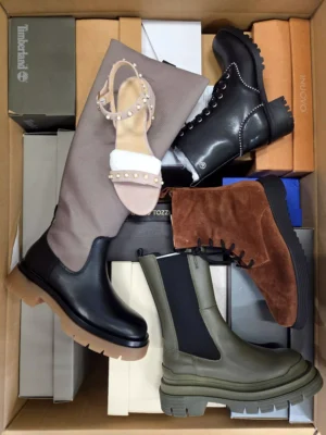 The photo shows a package with footwear in the category AS.