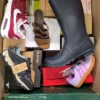 The photo shows a package with footwear in the category BS.