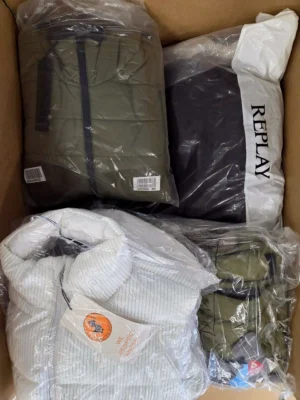 The photo shows a package with clothing in the category AJW.