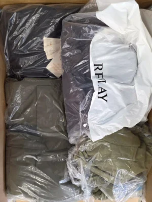 The photo shows a package with clothing in the category AJW.