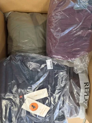 The photo shows a package with clothing in the category AJW.