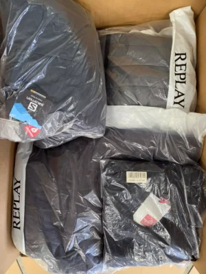The photo shows a package with clothing in the category AJW.