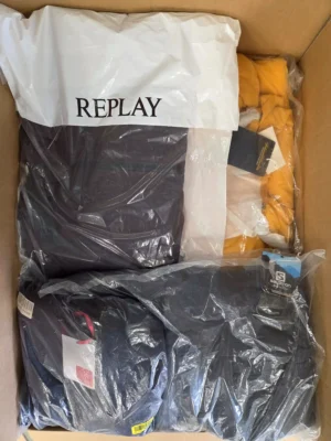 The photo shows a package with clothing in the category AJW.
