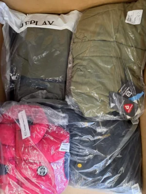 The photo shows a package with clothing in the category AJW.